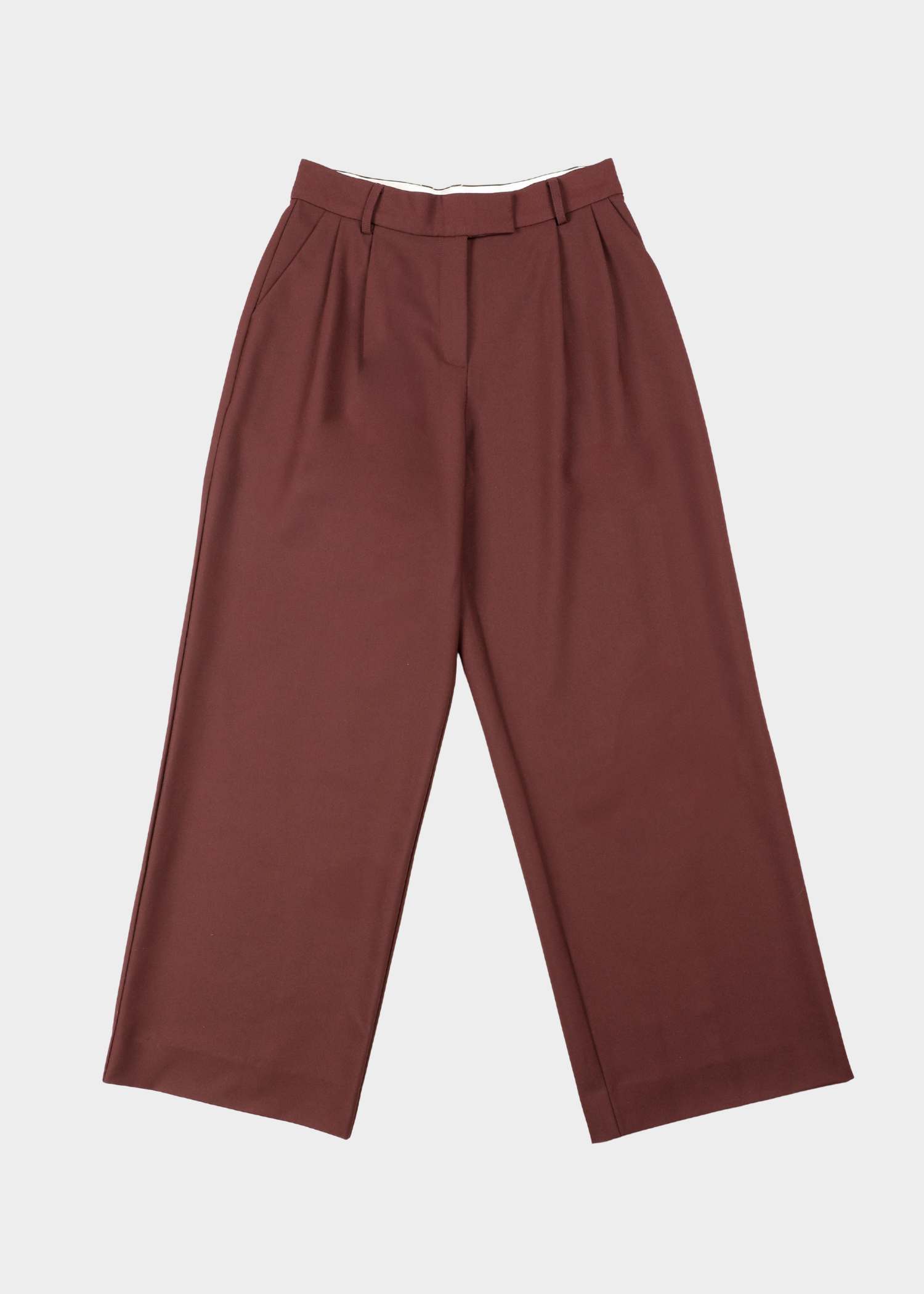 Abbi pants-Bordeaux Noted Antwerp. A pair of high-waisted, wide-leg trousers in a muted reddish-brown or rust color, shown flat against a light gray background.