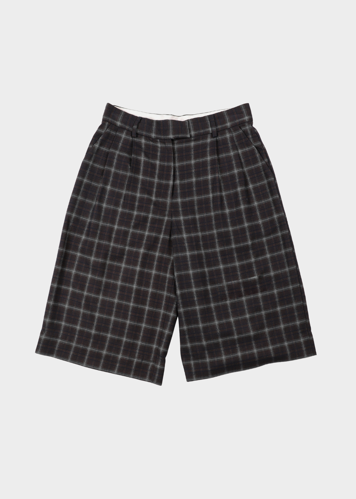 Noted Natwerp abbu bermuda checkered. Black and gray plaid shorts with a white waistband, displayed flat against a light gray background.