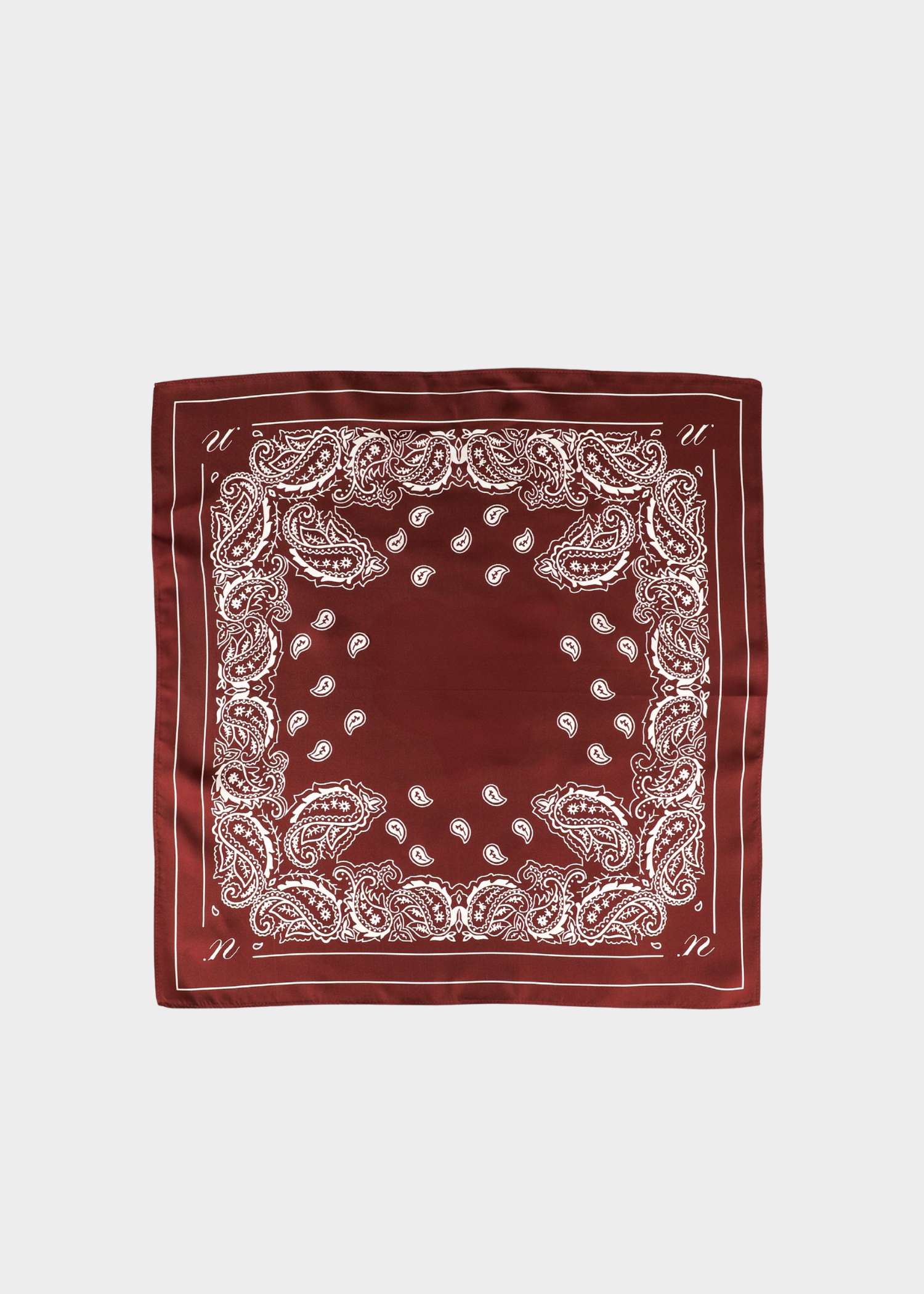 A square bandana scarf in deep burgundy with a white paisley border pattern, laid flat against a light gray background.