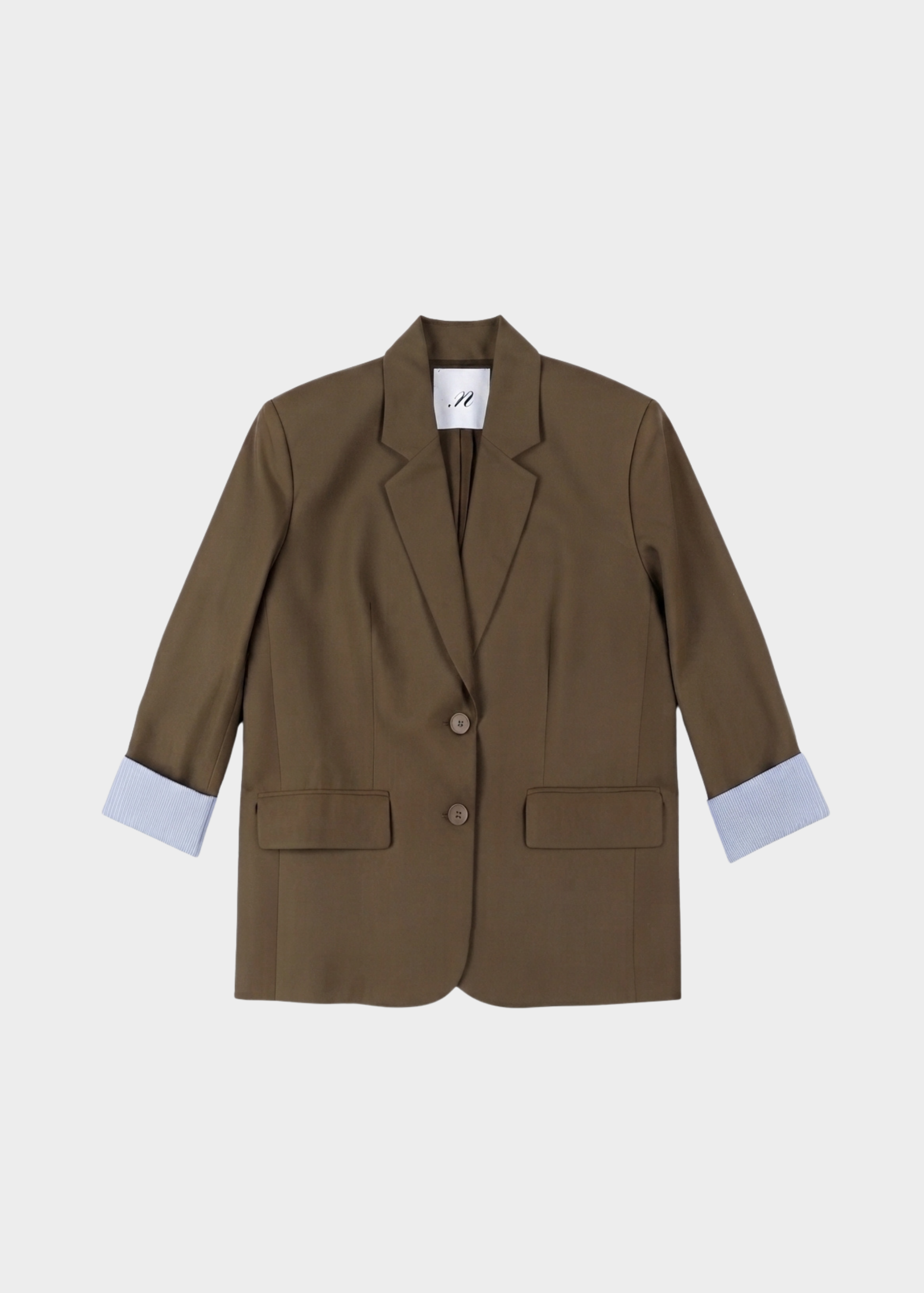 A brown tailored blazer with notched lapels, a two-button front, flap pockets, and light blue shirt cuffs turned up, shown on a light gray background.