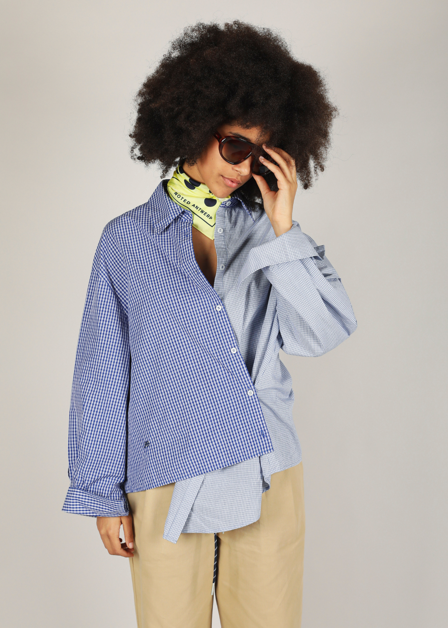 Womans assymetric blue checkered shirt with noted logo