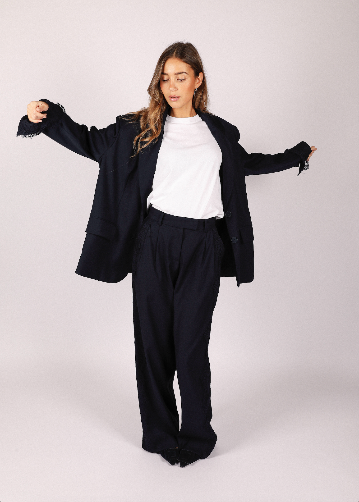 Woman wearing dark navy noted antwerp suit